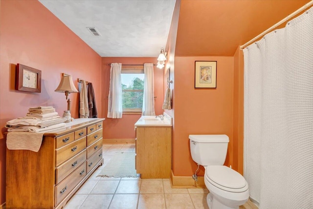 bathroom with vanity, tile patterned flooring, and toilet