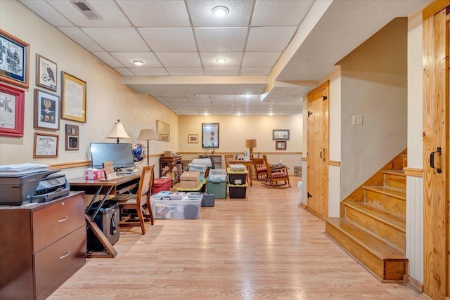 office featuring a drop ceiling and light hardwood / wood-style floors