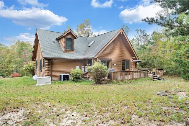 back of house with a deck and a lawn