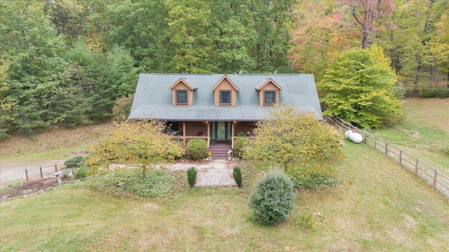 view of front of home with covered porch and a front lawn