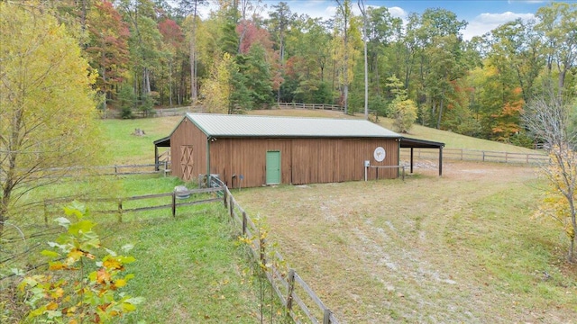 view of outdoor structure with a yard and a rural view