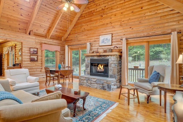 living room featuring beam ceiling, high vaulted ceiling, wooden ceiling, light wood-type flooring, and a fireplace