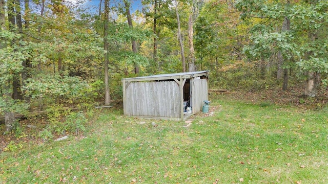 view of outbuilding featuring a yard