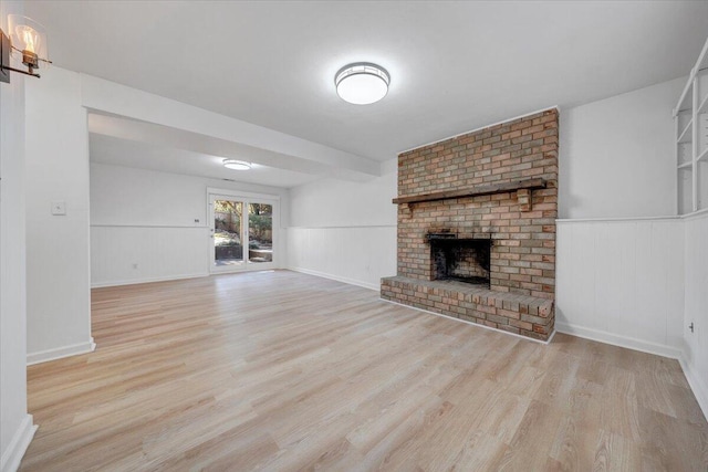 unfurnished living room featuring a fireplace and light wood-type flooring