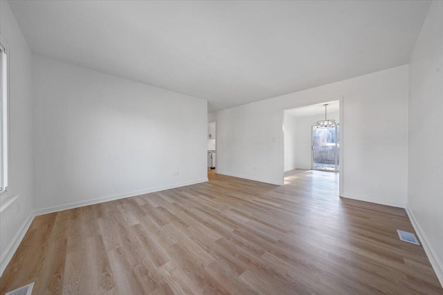 spare room with light hardwood / wood-style flooring