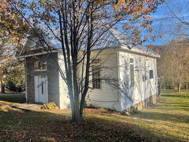 view of side of property with a yard