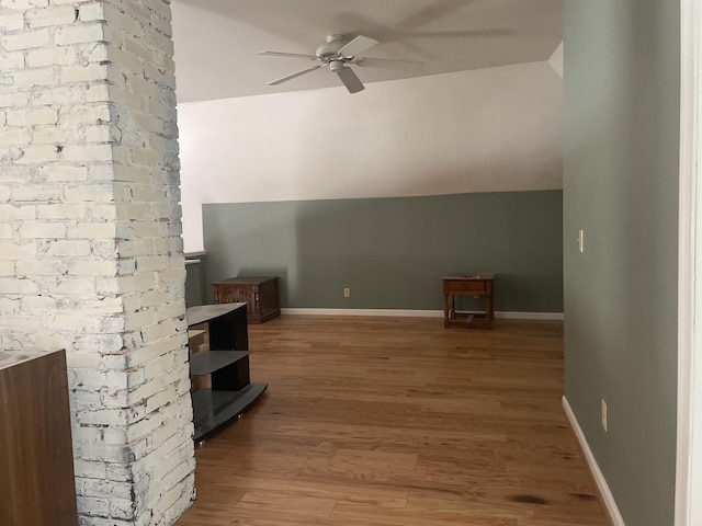 bonus room with ceiling fan, vaulted ceiling, wood finished floors, and baseboards