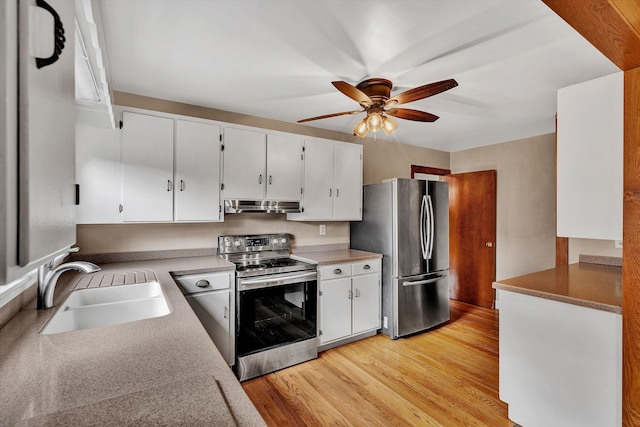 kitchen featuring white cabinets, sink, light hardwood / wood-style flooring, ceiling fan, and appliances with stainless steel finishes