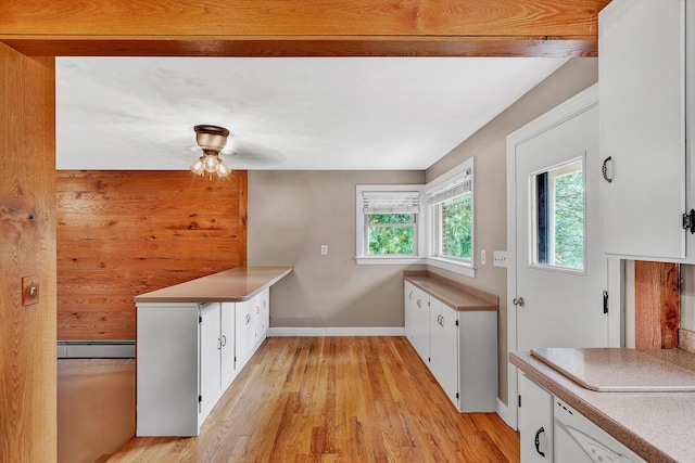 kitchen with white cabinets, ceiling fan, light wood-type flooring, and a baseboard heating unit