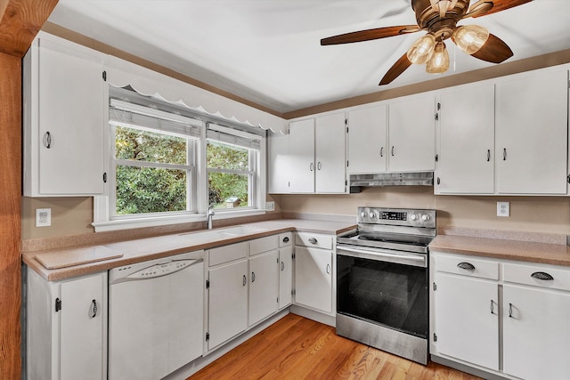 kitchen featuring light wood-type flooring, white dishwasher, sink, electric stove, and white cabinetry