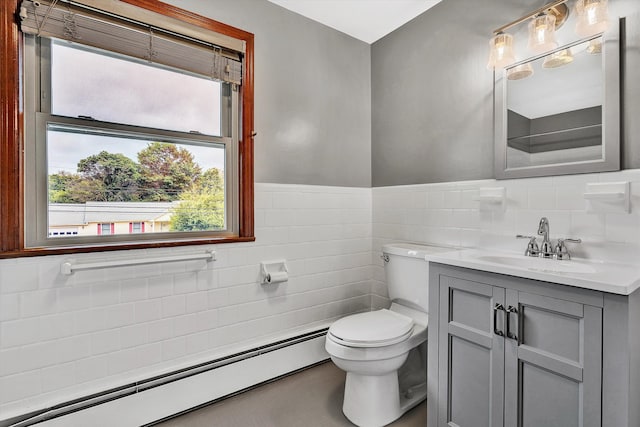 bathroom featuring vanity, toilet, baseboard heating, and tile walls