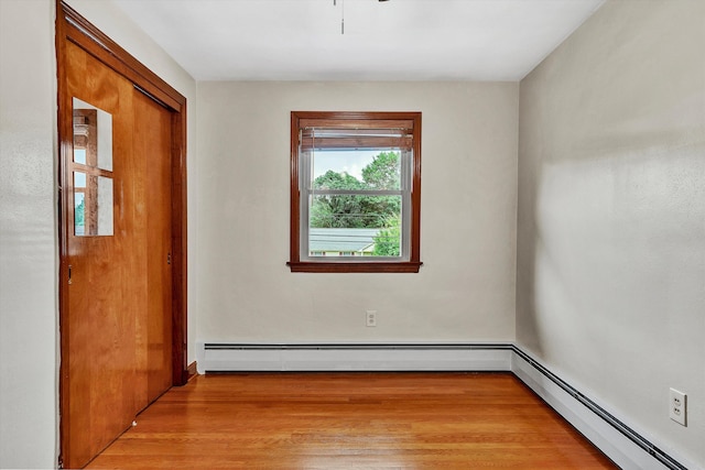 spare room featuring light hardwood / wood-style floors and a baseboard radiator