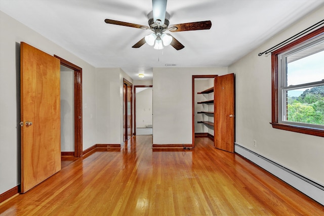 unfurnished bedroom featuring ceiling fan, light hardwood / wood-style floors, and baseboard heating