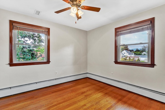 empty room with baseboard heating, ceiling fan, and wood-type flooring