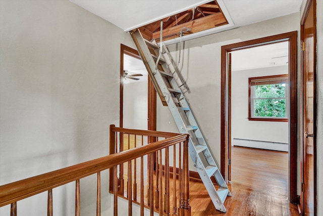 hallway featuring light hardwood / wood-style flooring and a baseboard heating unit