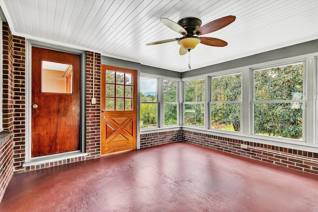 unfurnished sunroom featuring ceiling fan and wood ceiling