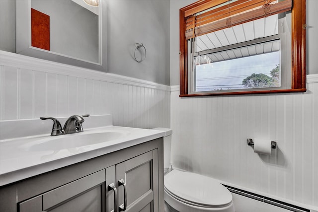 bathroom with vanity, a baseboard radiator, and toilet