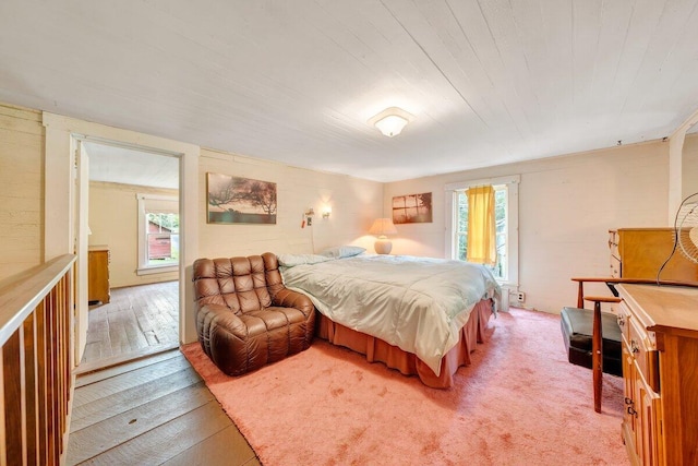 bedroom with hardwood / wood-style floors and multiple windows