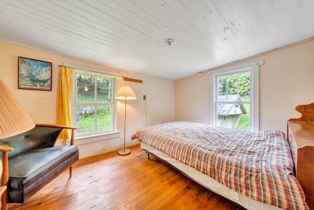 bedroom featuring hardwood / wood-style floors and lofted ceiling