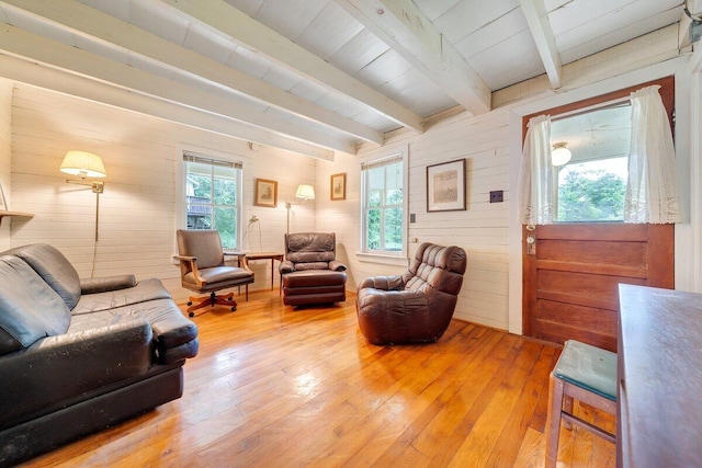 living room with hardwood / wood-style flooring, beam ceiling, wood walls, and wooden ceiling