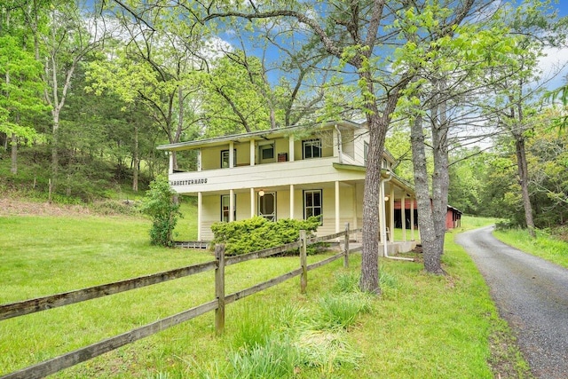 view of front of property with a porch and a front lawn