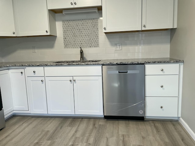 kitchen featuring sink, white cabinets, stainless steel dishwasher, and light hardwood / wood-style floors