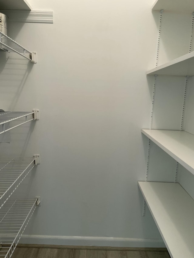 spacious closet featuring hardwood / wood-style floors