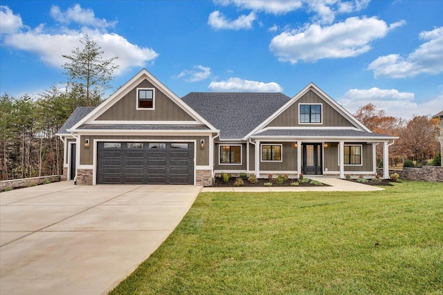 craftsman-style home featuring a porch, a garage, and a front lawn