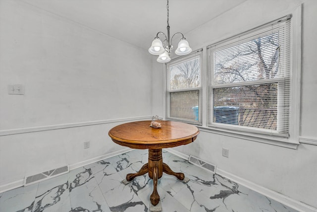 dining area with an inviting chandelier