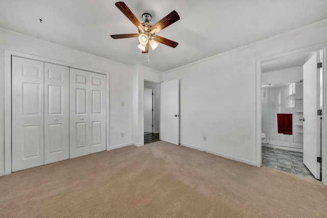 unfurnished bedroom featuring light colored carpet, ceiling fan, crown molding, connected bathroom, and a closet