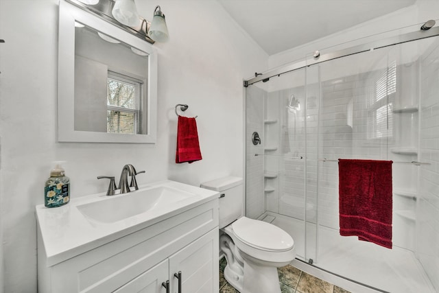 bathroom featuring tile patterned flooring, vanity, toilet, and walk in shower