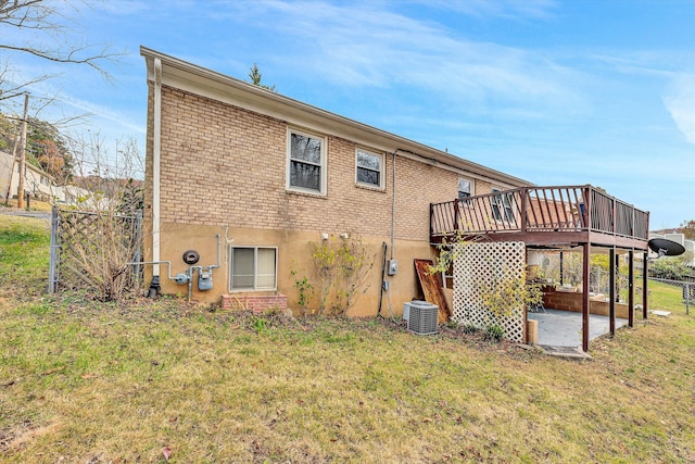 back of property with a patio, a deck, and a lawn