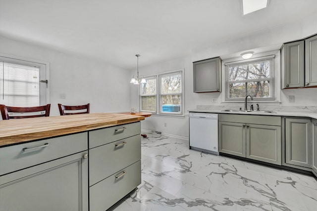 kitchen featuring a notable chandelier, white dishwasher, sink, gray cabinets, and decorative light fixtures