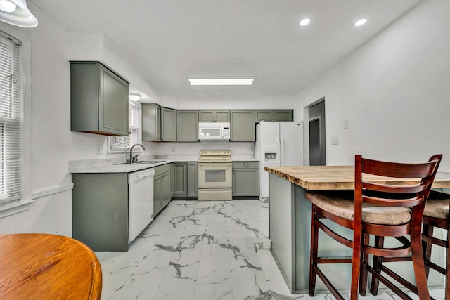 kitchen featuring sink and white appliances