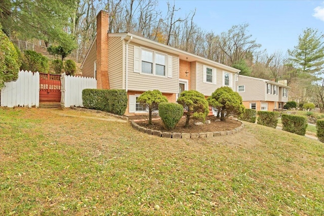 raised ranch featuring a front lawn