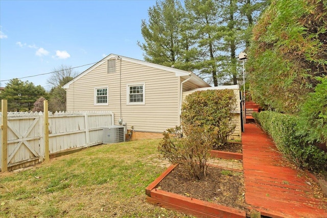 view of home's exterior with central AC and a lawn