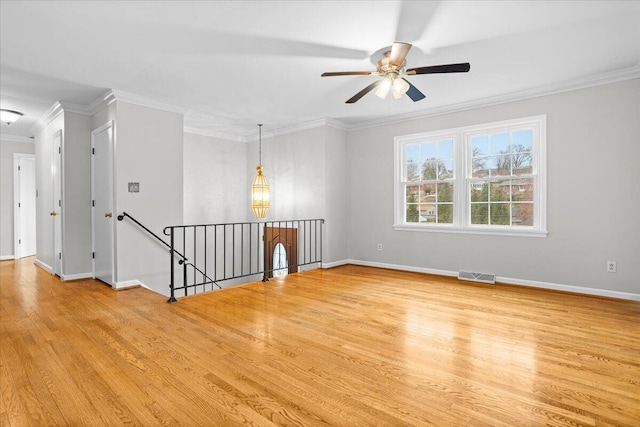 unfurnished room with light hardwood / wood-style floors, ceiling fan, and ornamental molding