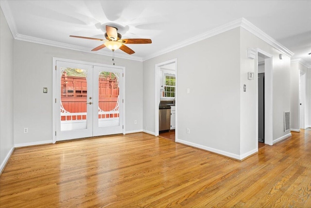 empty room featuring crown molding, french doors, ceiling fan, and light hardwood / wood-style floors