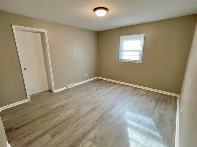 spare room with light hardwood / wood-style flooring