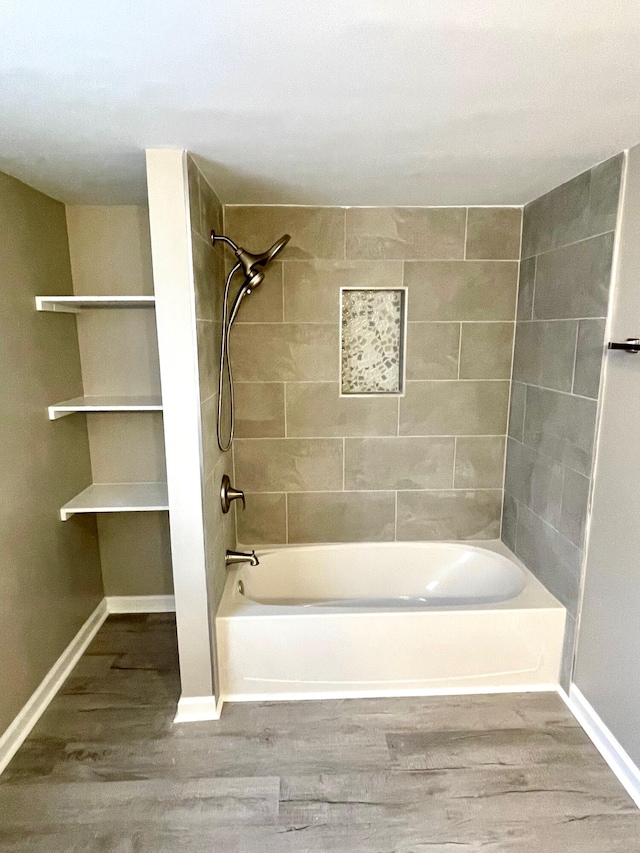 bathroom featuring hardwood / wood-style floors and tiled shower / bath