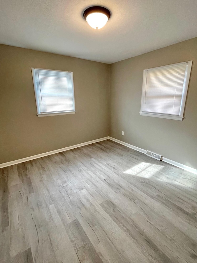 unfurnished room featuring light hardwood / wood-style floors