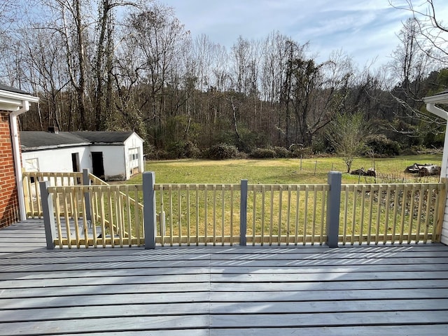 wooden terrace featuring an outdoor structure and a lawn