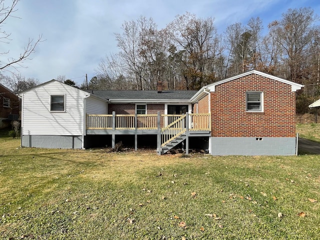 back of property featuring a yard and a wooden deck