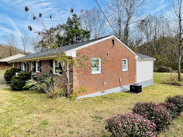 view of side of home featuring a lawn, a porch, and central AC