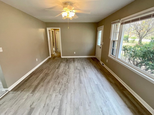 empty room featuring ceiling fan and light hardwood / wood-style flooring