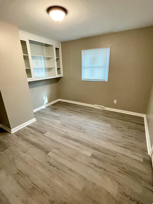 spare room featuring hardwood / wood-style flooring