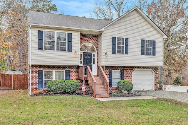 split foyer home featuring a garage and a front lawn