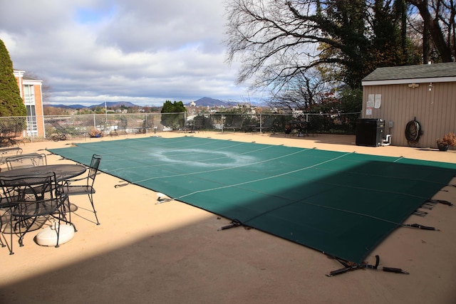 view of swimming pool with a mountain view and a patio