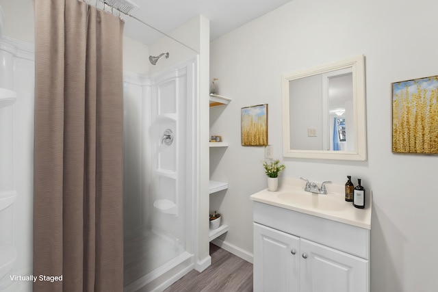 bathroom featuring hardwood / wood-style floors, vanity, and a shower with shower curtain