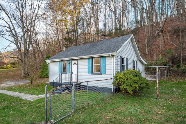 bungalow-style home featuring a front lawn